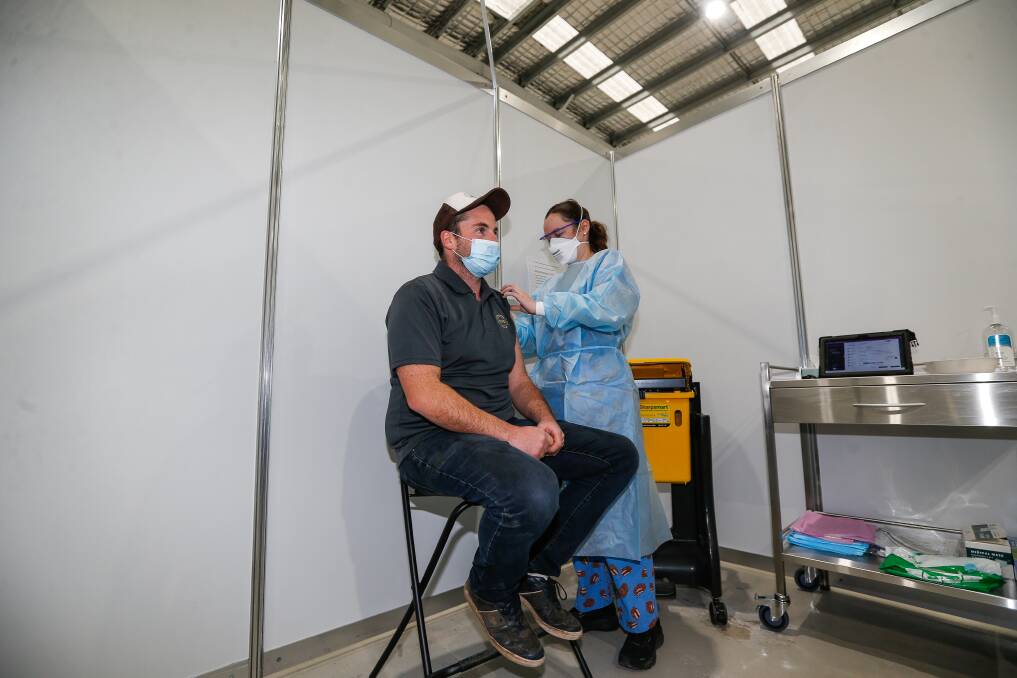COVID vaccine nurse Christa McLeod at the COVID vaccaniation centre in Warrnambool with Timboon's Josh Walker earlier this year. Picture: Anthony Brady