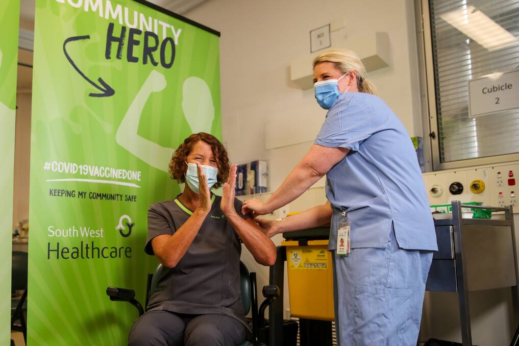 History: Carole Holman was the first to receive the vaccine in Warrnambool, Tina Jess was on hand to administer the vaccination. Picture: Morgan Hancock