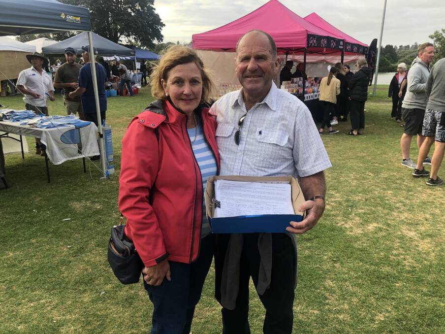 Allansford residents Jill and Mick Mahony at the market with their petition 'Build Roads Not Barriers'. Picture: Kyra Gillespie