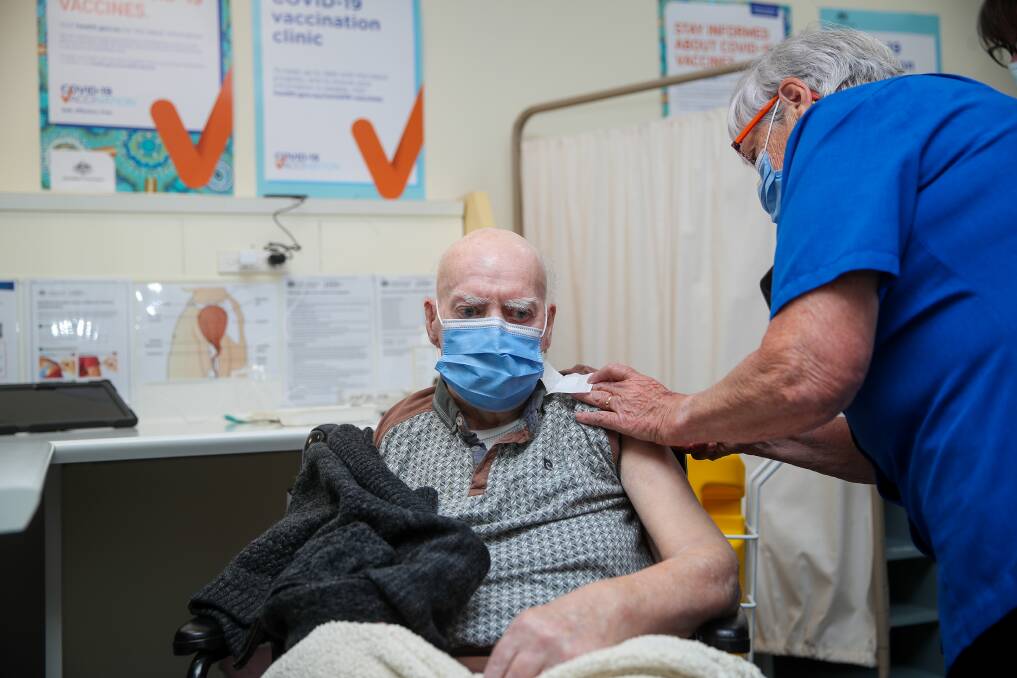 Bev McIlroy administers the vaccine to Ted Adams, 93, who was the second person to receive the vaccine in south-west Victoria. Picture: Morgan Hancock