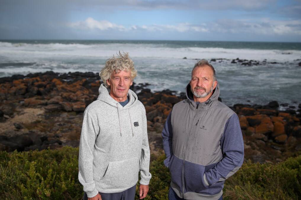 Surfers Tim Dryden and Mark Archbold say they have had their health impacted by brown sludge in the surf. Picture: Morgan Hancock