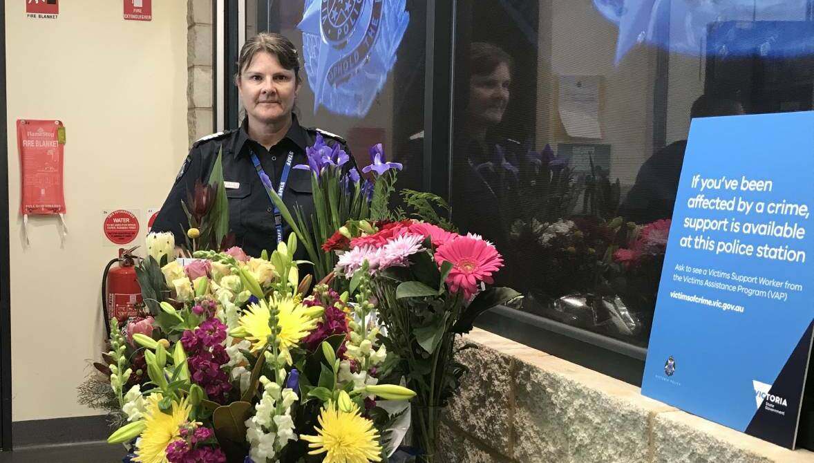 Tributes: Warrnambool Senior Sergeant Tania Barbary with some of the flowers community members have sent to the Warrnambool police station after the death of four officers in Melbourne on Wednesday evening. Picture: Andrew Thomson