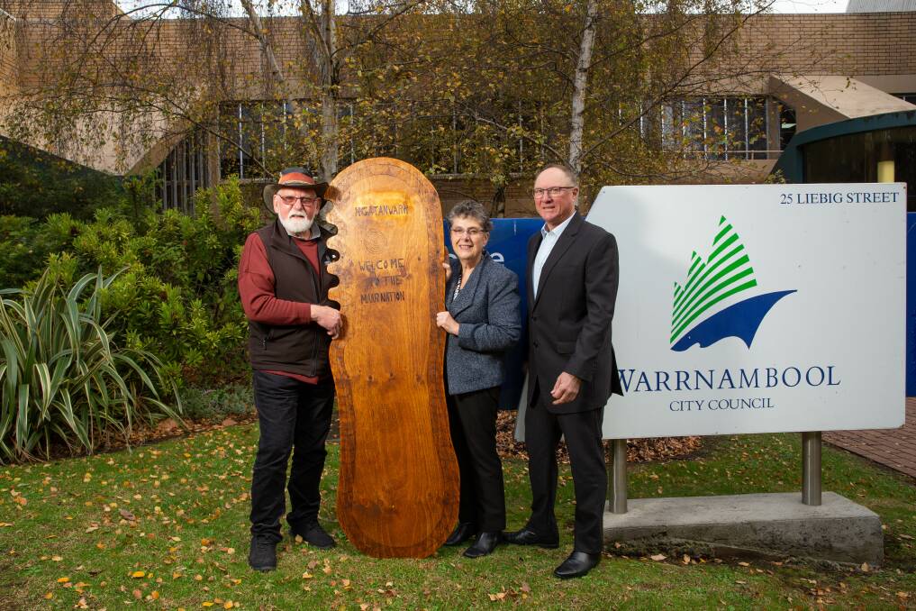 Uncle Rob Lowe Senior presenting mayor Vicki Jellie and interim chief execute officer of Warrnambool City Council, Gary Gaffney with a message stick as part of Reconciliation Week. Picture: Chris Doheny