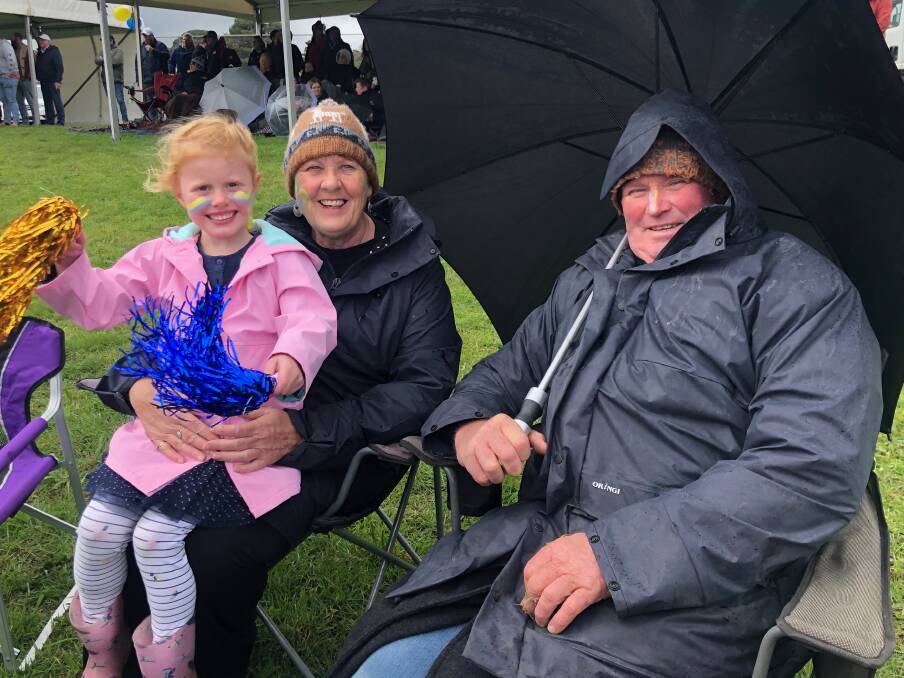 Keen supporters: Kaye Sheldon with granddaughter Audrey Sheldon, 5, and Gary Somerville watching the football. They travelled from Bendigo for the HFNL grand final. Picture: Kyra Gillespie