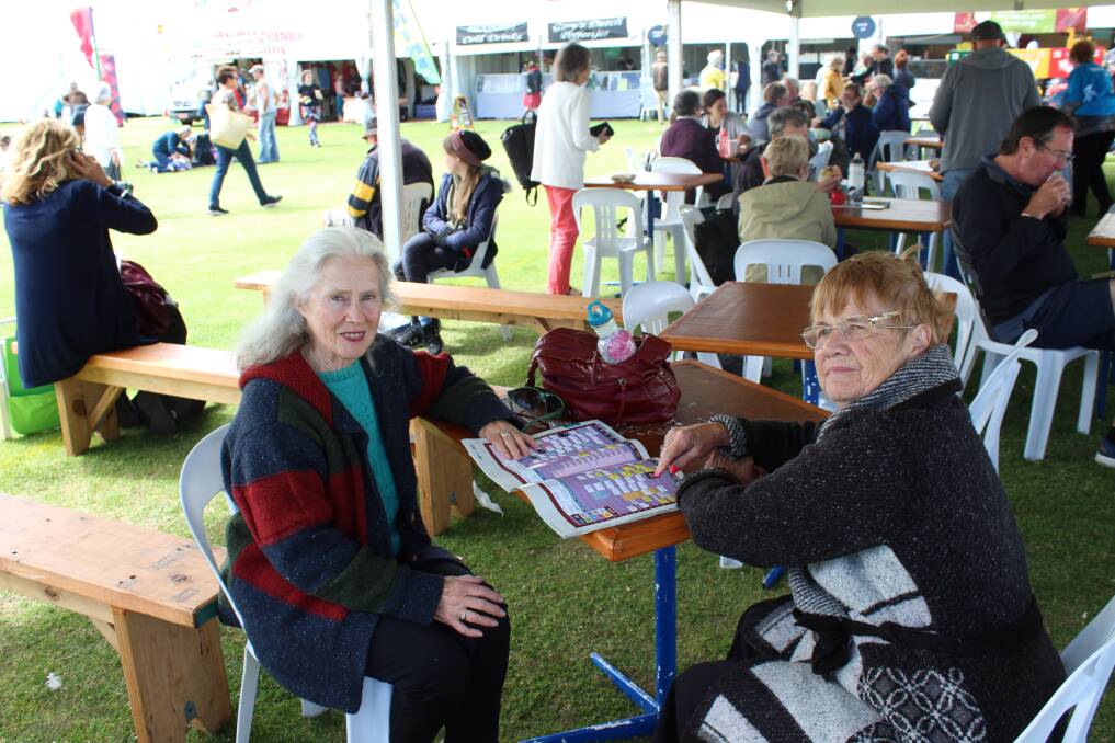 Geraldine and Penny peruse the Port Fairy Folk Festival program. 