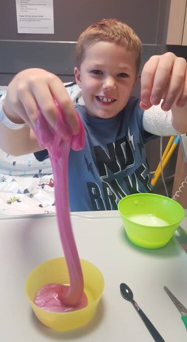 South West Healthcare patient Mason receives a slime kit from Koala Kids Foundation during Science Week. 