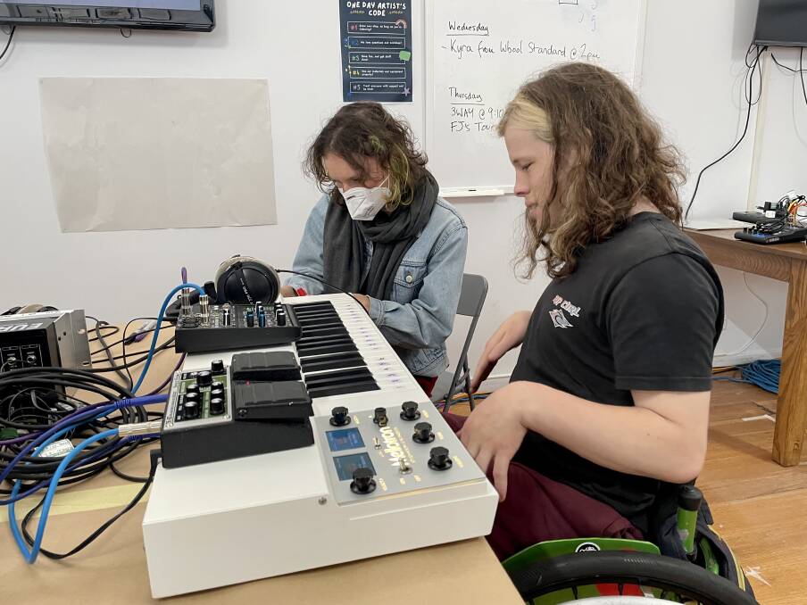 Students learning about synthesizers and drum machines. 