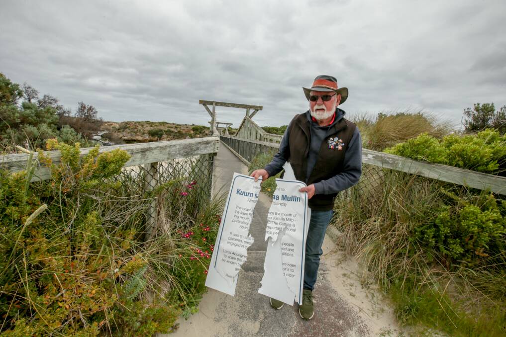 NOT ON: Indigenous elder Robbie Lowe with a recently vandalised sign that required to be replaced. Picture: Chris Doheny