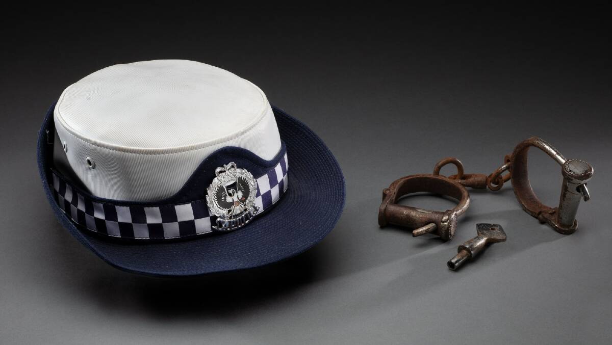Police hat and handcuffs, on loan from Leanne Liddle. Picture: National Museum of Australia