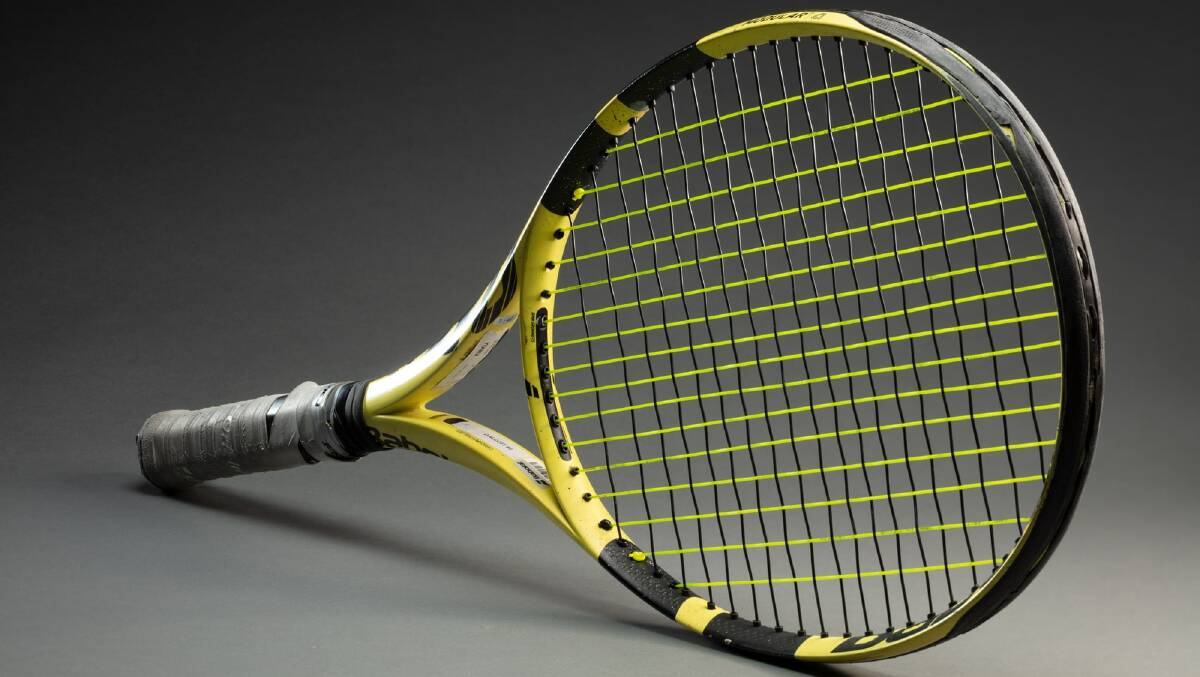 Tennis racquet used at the Tokyo Paralympics 2021, on loan from Dylan Alcott. Picture: National Museum of Australia