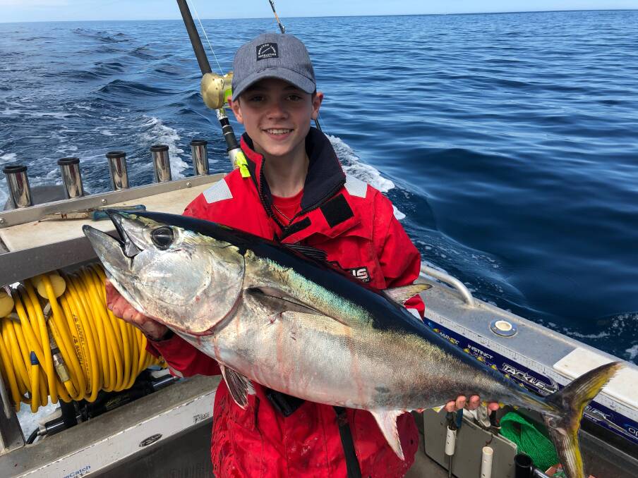 Big catch: Young Warrnambool angler Oska Wilson, 14, with the tuna he caught around one kilometer south of the Breakwater on Sunday, as schools of southern bluefin tuna chased bait fish close to shore. Picture: Supplied
