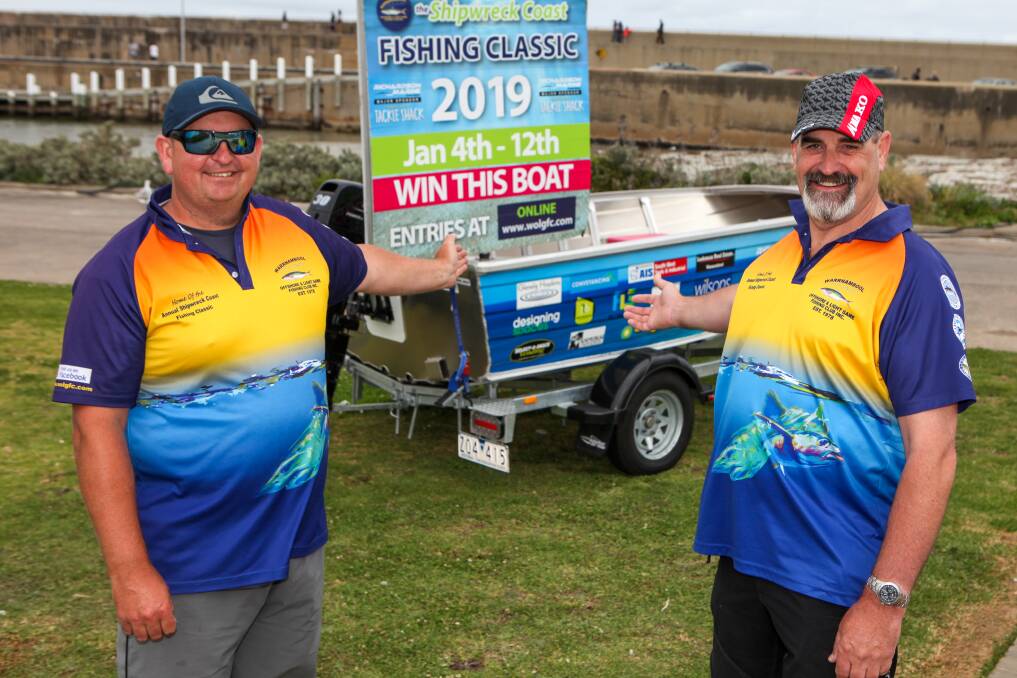 Hook onto this: Warrnambool Offshore and Light Game Fishing Club vice president Sam Powell and president Peter Goode show off the boat that will be won by a lucky fisherperson. Picture: Rob Gunstone