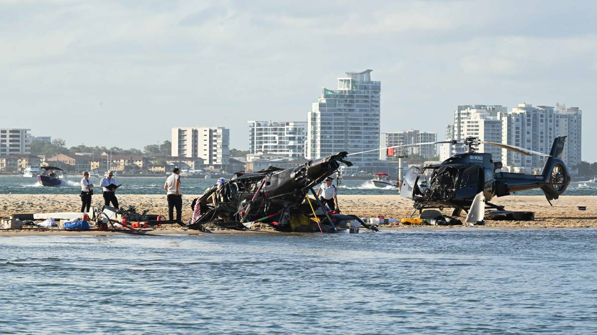 The wreckage of two helicopters are seen following a collision near Seaworld. Picture by AAP Image/Dave Hunt