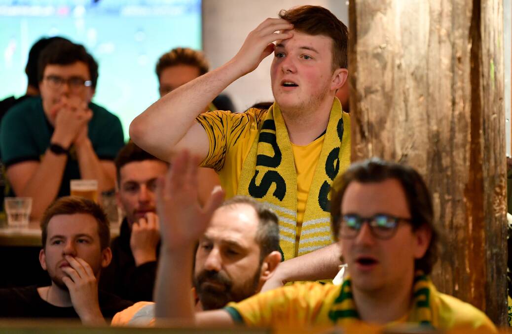 Socceroos fans react as they watch Australia play France in the 2022 FIFA World Cup at Cheers Bar in Sydney. Picture by AAP Image/Bianca De March