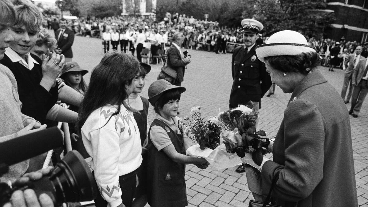 Eight-year-old Danielle Coulson, front and centre, presents a bouquet of flowers to the Queen in Launceston in 1988.