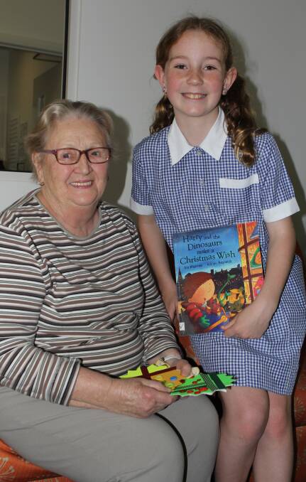 'Tis the season: St Pius Primary School student Matilda Sewell, 10, shared a Christmas story and hand-made decoration with Mercy Place resident Inez Douglass.