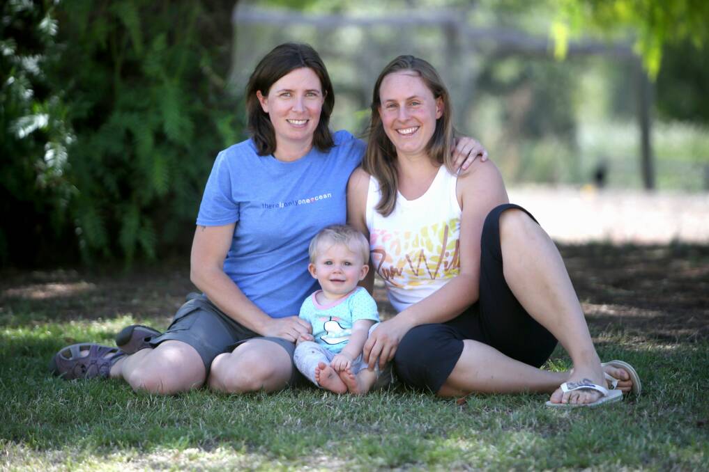 Mothers and teachers, Alison Coate-Kibeiks and Bianca Prziovska-Kibeiks with their one-year-old daughter Olive Coate-Kibeiks. Picture: Amy Paton