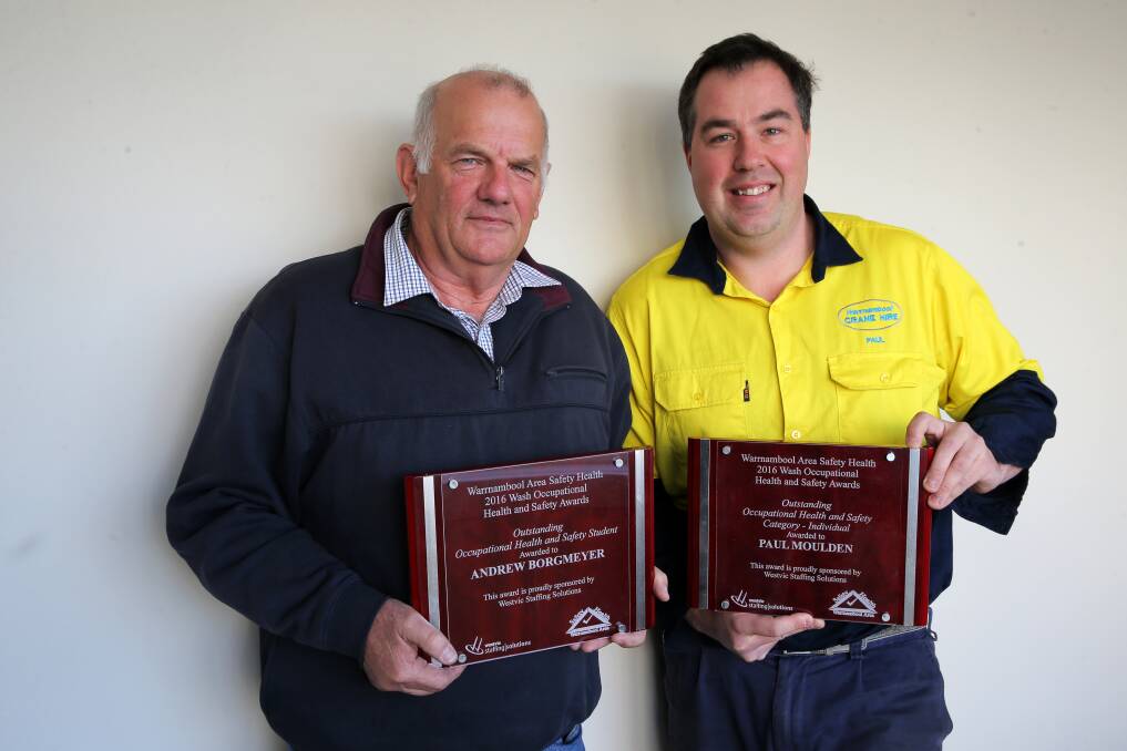 Awards: Lance Mason, on behalf of Andrew Borgmeyer, and Paul Moulden received awards for outstanding occupational health and safety on Tuesday. Picture: Rob Gunstone