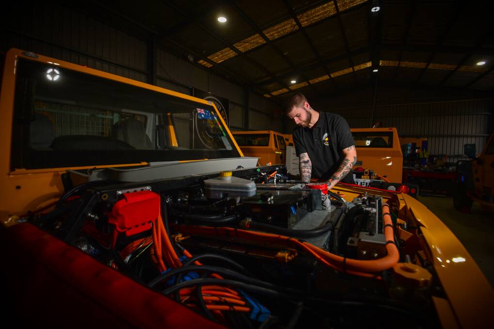 apprentice Jesse Carolan works on one of 10 prototype Bortanas expected to be rolled out for road testing in mines from April. Picture: DARREN HOWE