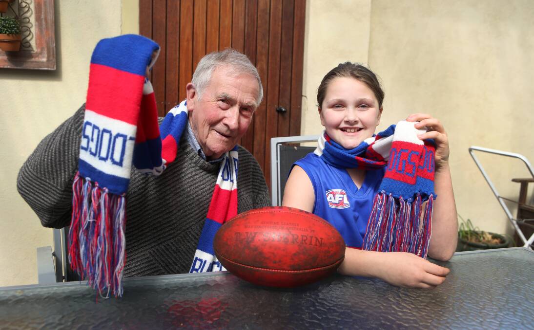 HISTORY IN THE MAKING: Ian Fawcett and his granddaughter Alice, 9, will be cheering on the Bulldogs when they take on Sydney in Saturday's AFL grand final. Picture: Amy Paton