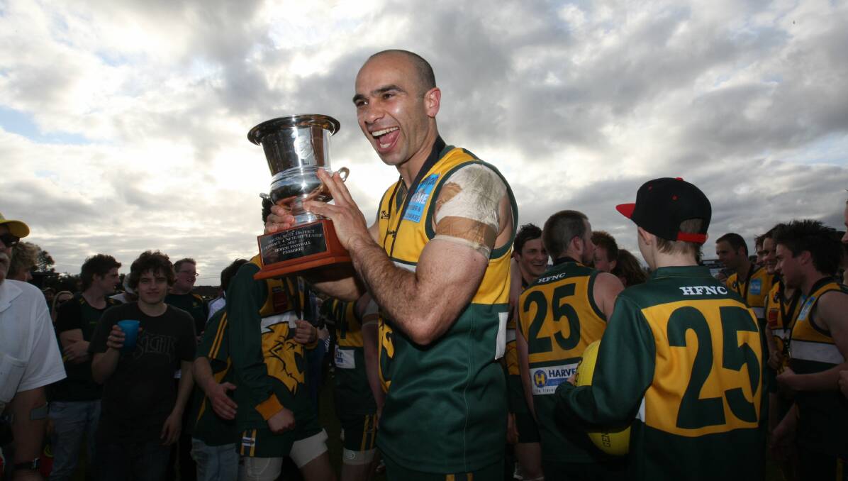 WINNING WAYS: Jason Saunders celebrates taking out the 2012 SWDFNL grand final with Heywood - the club's first flag in 53 years.