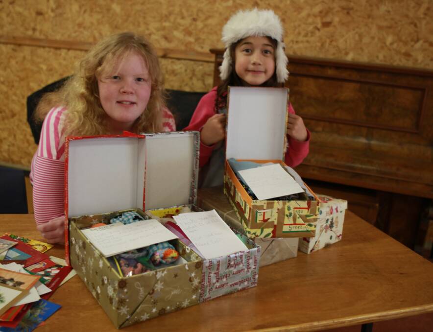Emily Coleman, 12, and Sierra Pritchard, 8, with the boxes they filled for Operation Christmas Child.