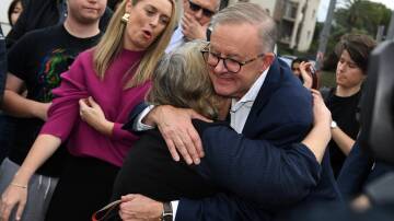 Labor leader Anthony Albanese meets a supporter before the polls closed on Saturday. Picture: AAP