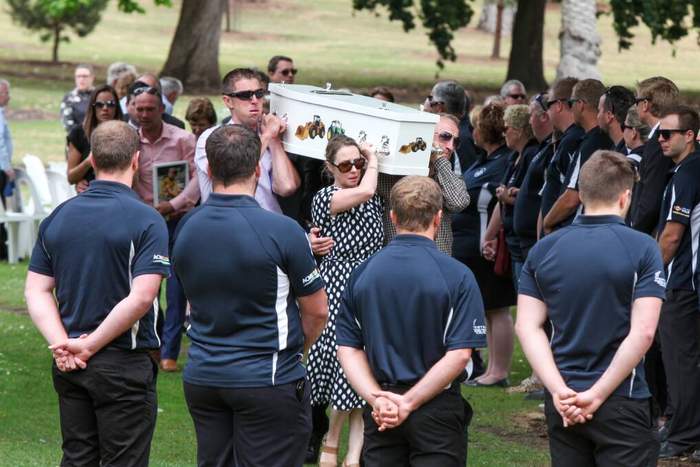 Allansford Football Club players form a guard of honour as the casket of Darcy Membrey is carried away from the service. Picture: Rob Gunstone
