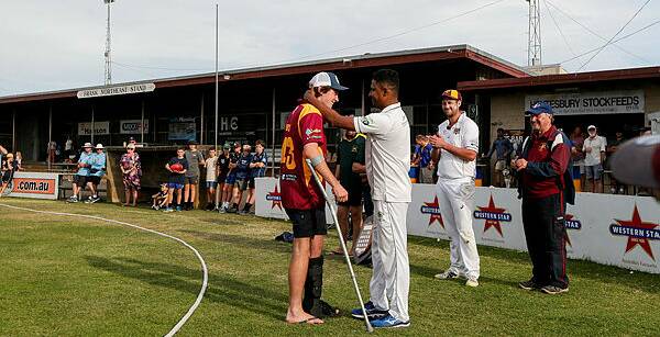 Special gesture: Pomborneit's Tharaka Sendanayake gives his medal to injured teammate Tom Darcy after the South West Cricket Association grand final between Mortlake and Pomborneit. Picture: Anthony Brady