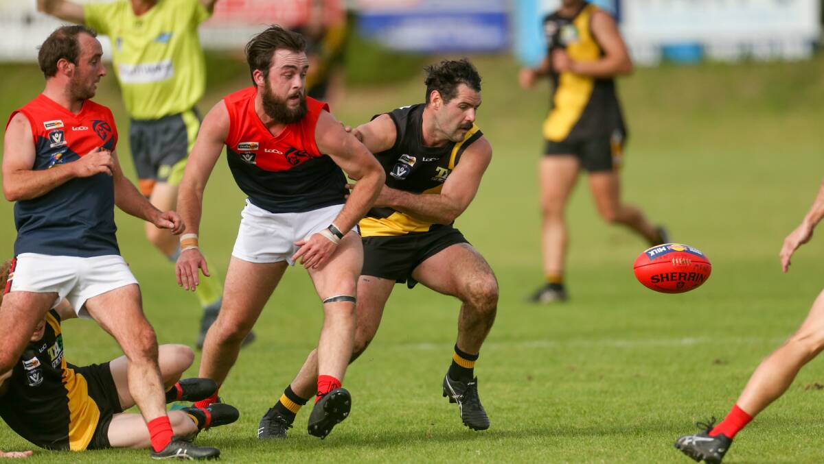 In dispute: Merrivale and Timboon Demons' players compete for the loose ball on Saturday. Picture: Chris Doheny