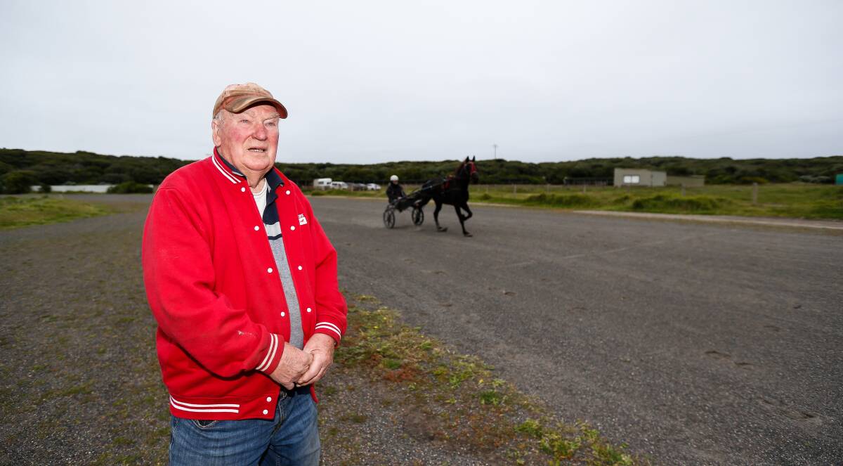 IN WORK: Geoff Senior by the track as driver Neil Kelly and trotter Icicle zoom past. 
