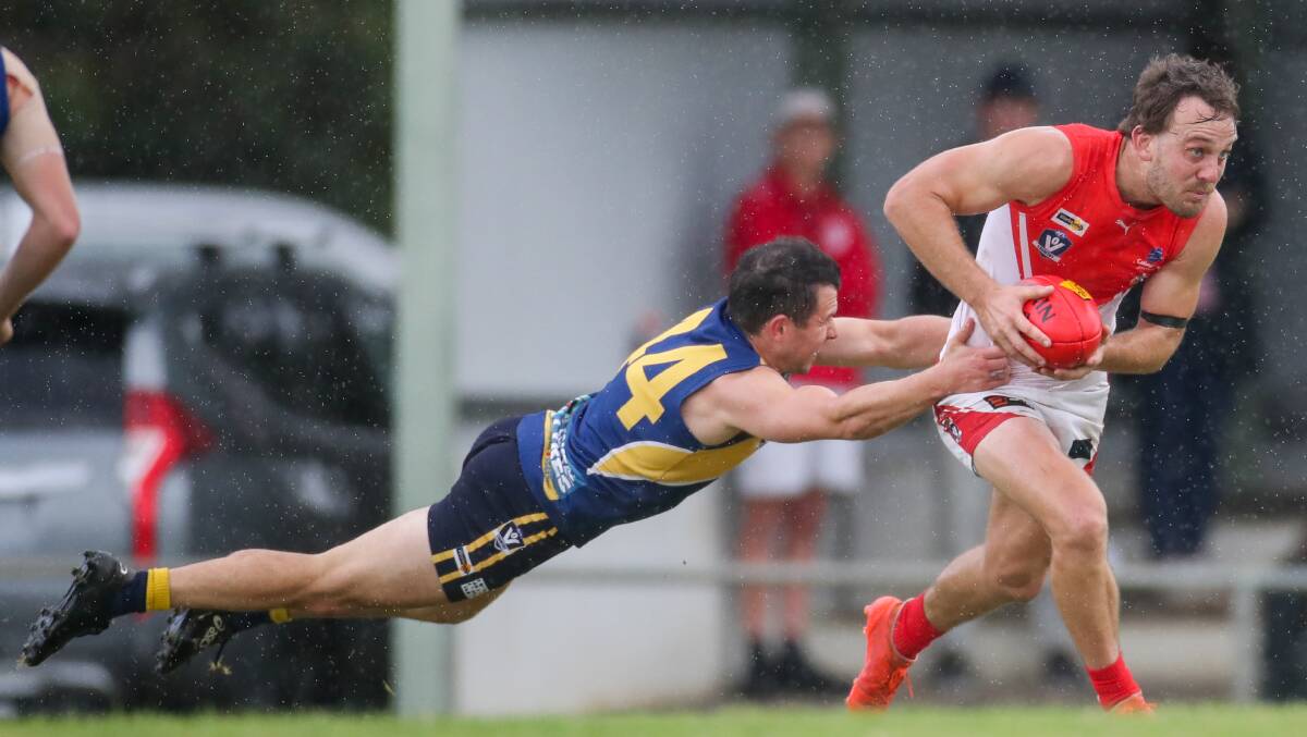 Getting away: South Warrnambool's Josh Saunders shrugs off a tackle from North Warrnambool Eagles' Jarryd Lewis. Picture: Morgan Hancock