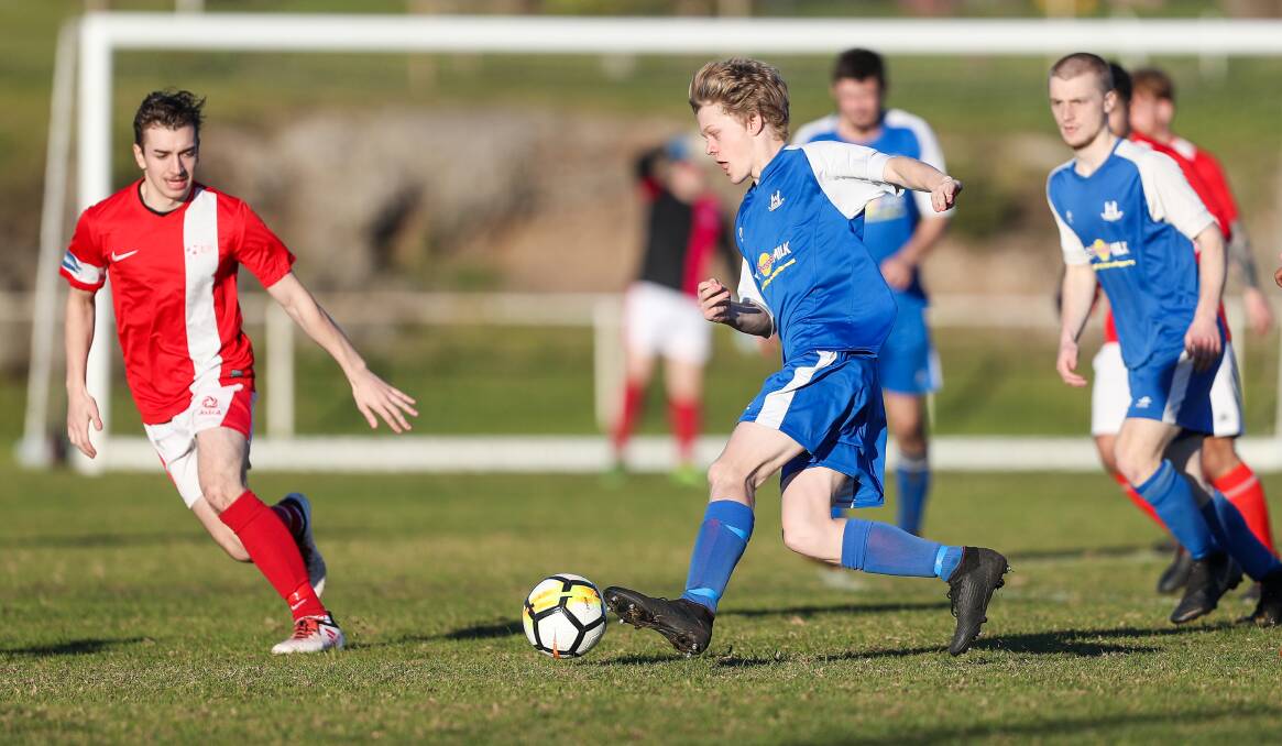Waiting game: Warrnambool Rangers' Owen Kirby runs with the ball last season. Grassroots soccer around Australia has been suspended until May 31. Picture: Morgan Hancock