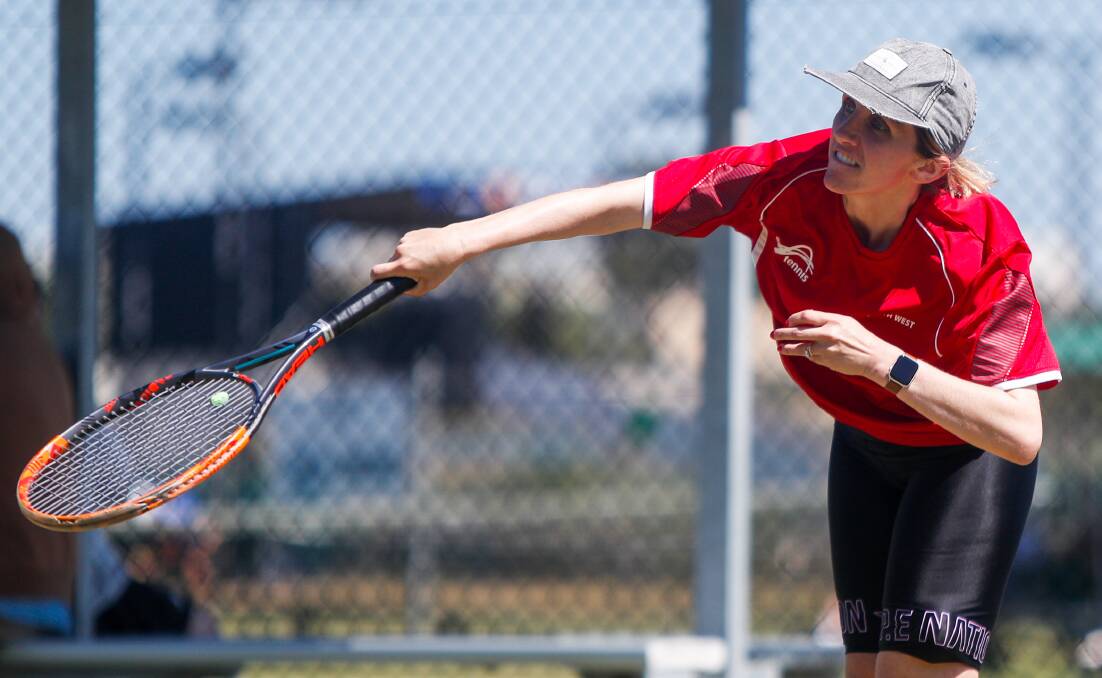 With momentum: Angie Paspaliaris serves during her women's 35-49 singles match on Friday.