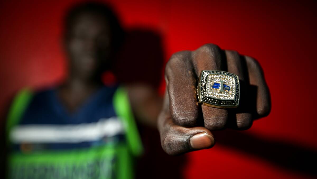 THE RING: Mojwok Akoch, 18, tries on an under 23 Seahawks Championship League ring. Picture: Chris Doheny