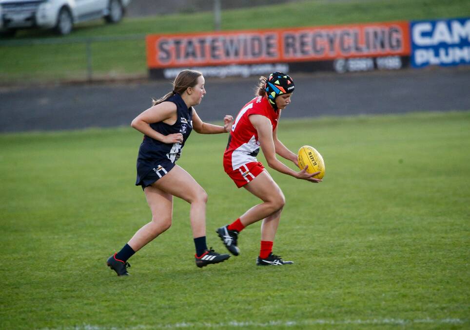 Taking possession: South Warrnambool's Hannah Rooke grabs the ball with Warrnambool's Isabelle Dix close by. Picture: Anthony Brady