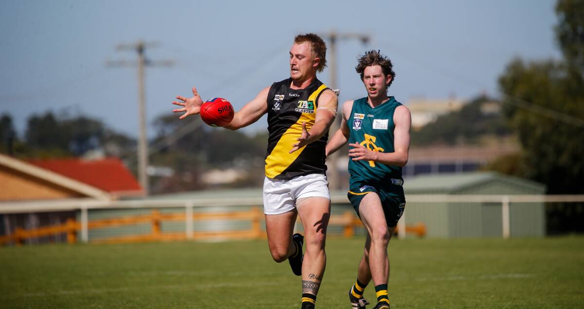 IN PURSUIT: Merrivale's Nathan Krepp and Old Collegians' Jonah Bowles get after the ball during the Warrnambool and District league Good Friday blockbuster clash this year. Picture: Anthony Brady 