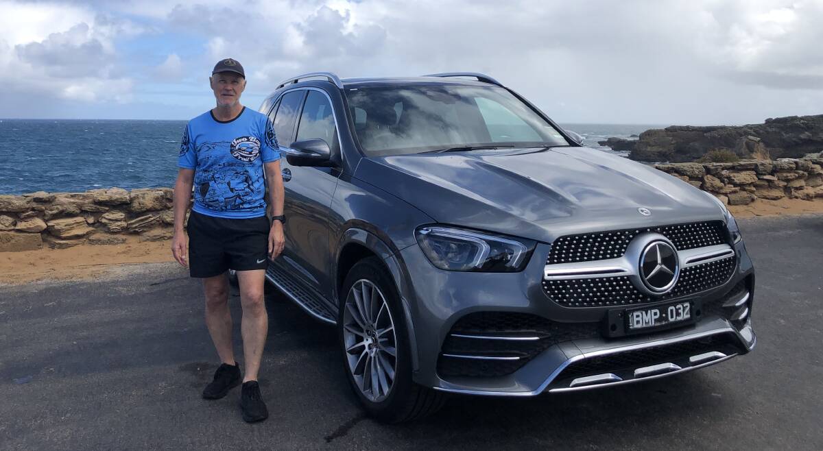 By the sea: Warrnambool Athletics Club committee member Kerry Clapham with a Callaghan Motors' Mercedes-Benz at Thunder Point. Picture: Brian Allen