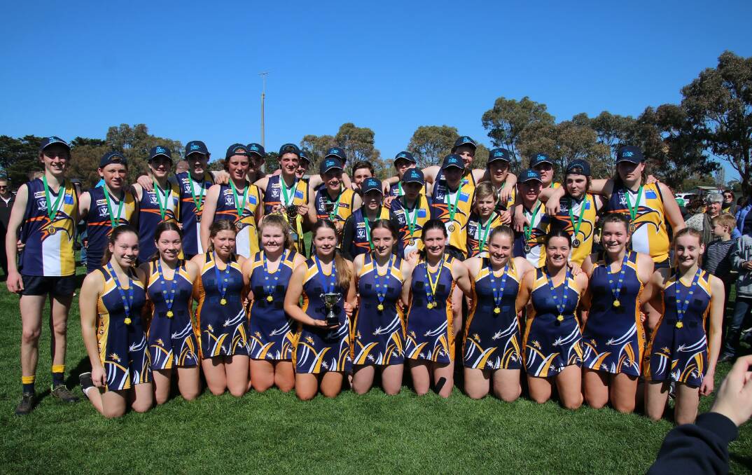 United: The Hawkesdale Macarthur under 16.5 football and 15 and under netball teams celebrate after their premiership wins. Picture: Tracey Kruger.