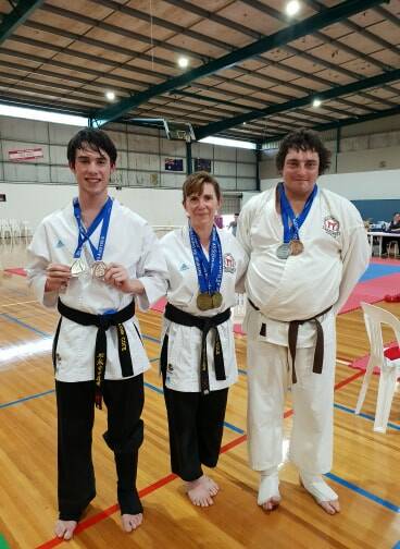 Medals: Tobi Cole, Jill Cole and William Kemp with their medals from round one of the National All Styles Karate Tournament. 