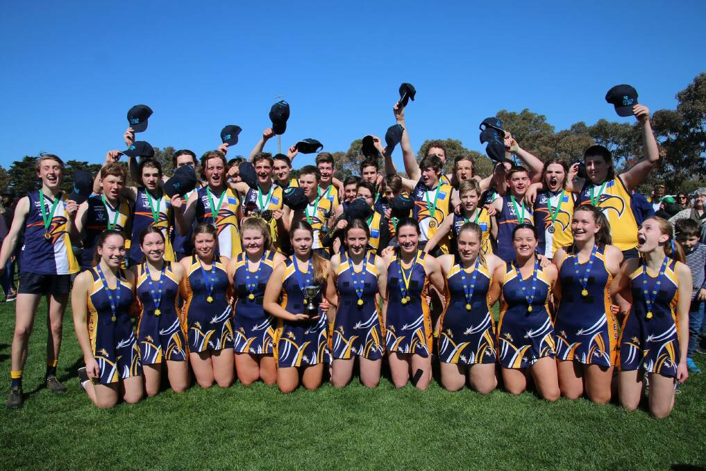 One: The Hawkesdale-Macarthur under 16.5 football and 15 and under netball teams celebrate after their premiership wins. Picture: Tracey Kruger. 