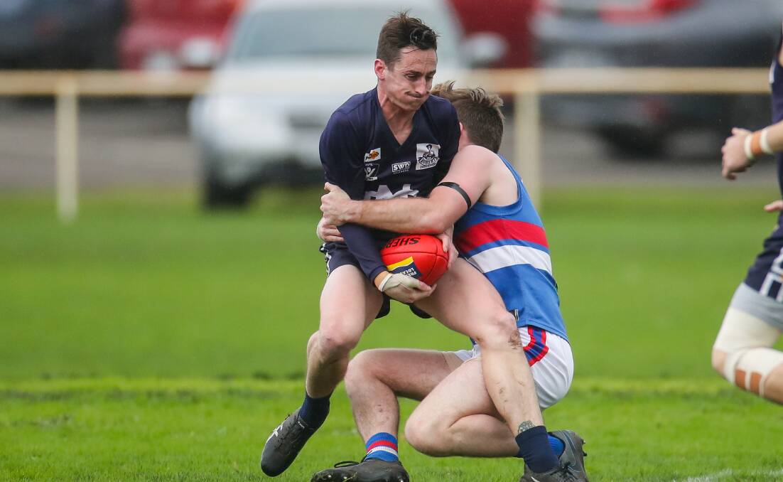 ALL OVER: Nirranda's Dylan Willsher is tackled earlier this season. The remainder of the Warrnambool and District league season is cancelled. Picture: Morgan Hancock 