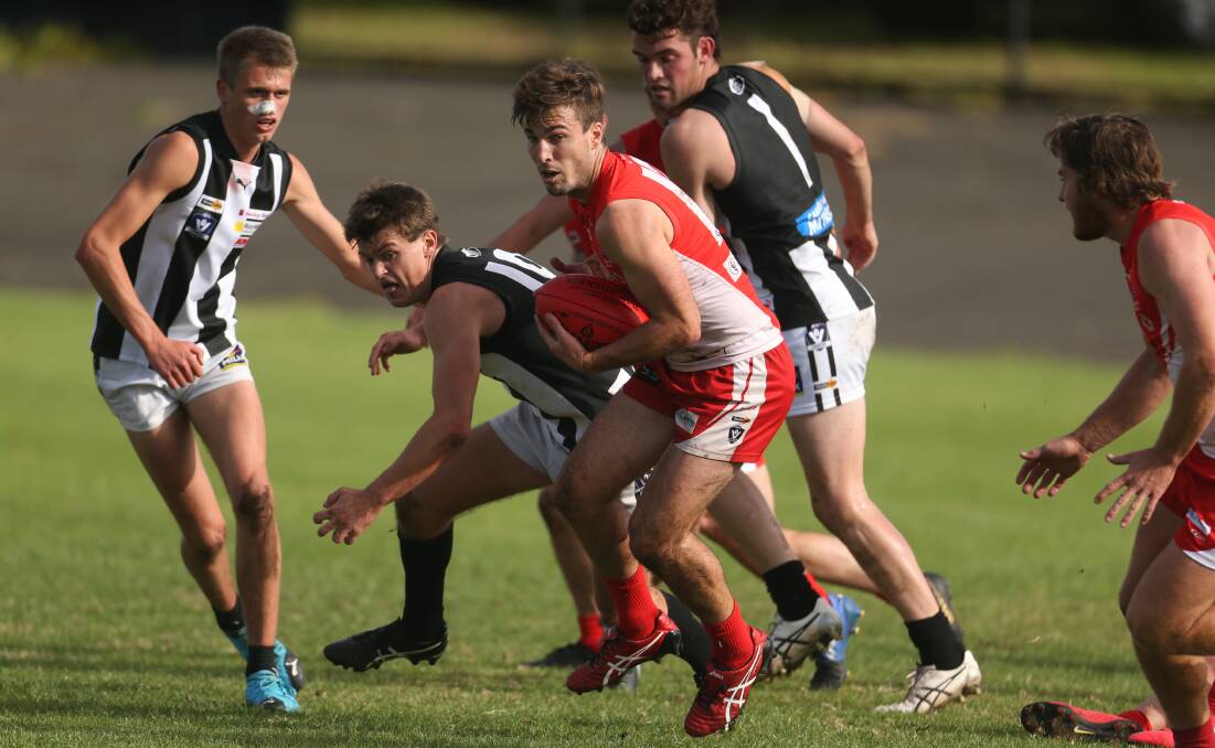 Both winners: South Warrnambool's Tait Niddrie with the ball against Camperdown. The Roosters and Magpies have received a grant from the state government. Picture: Chris Doheny
