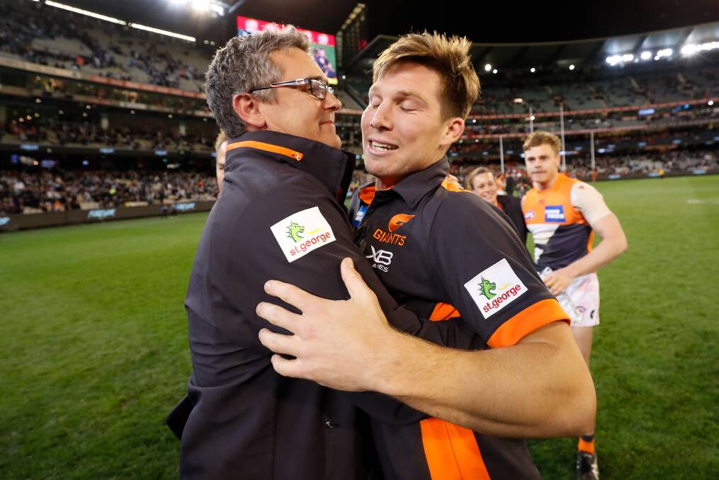 Fortunate: Coach Leon Cameron and suspended player Toby Greene embrace after the Giants' thrilling four-point preliminary final victory. Greene is eligible to play in the grand final. Picture: Getty Images.