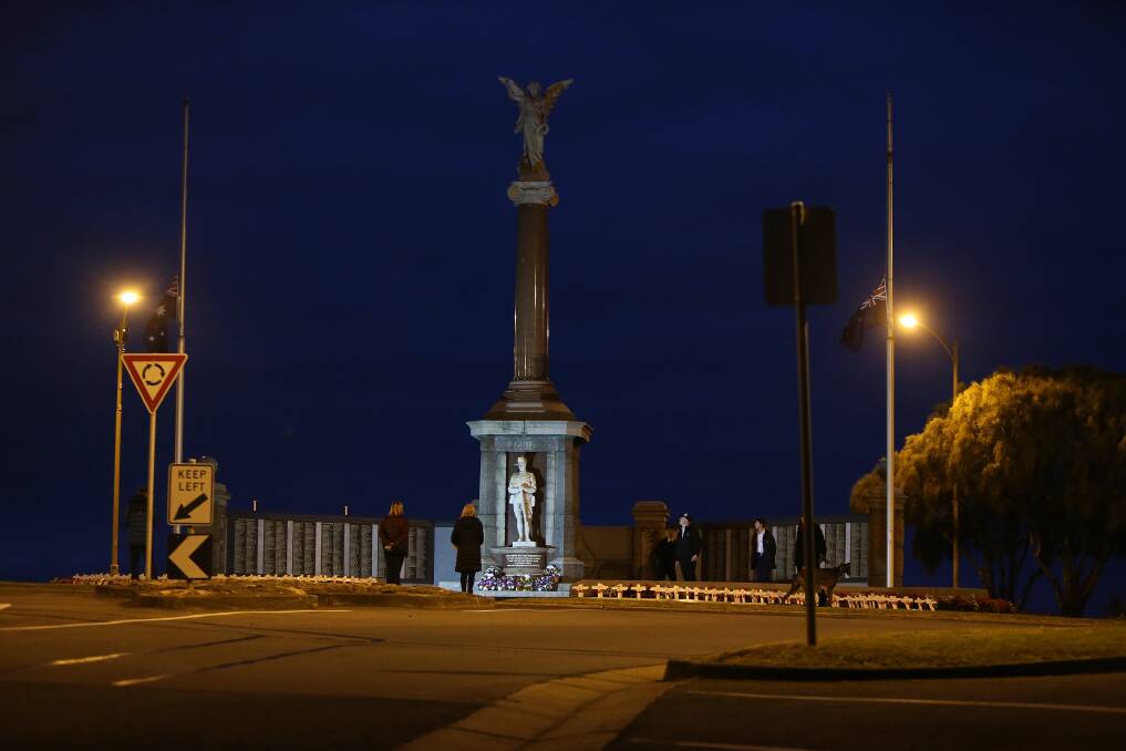 QUIET: People pay their respect at dawn on Anzac Day in Warrnambool. Picture: Mark Witte