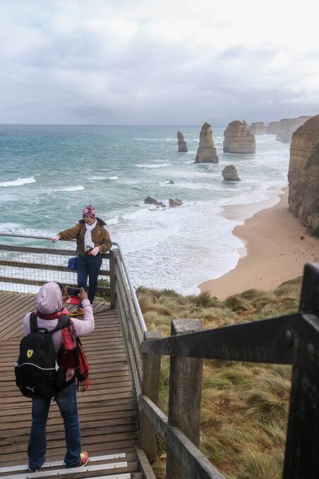 SMILE: Visitors snap a photo at the Twelve Apostles with the Great Ocean Road icon seeing a rise in international tourists. Picture: Amy Paton