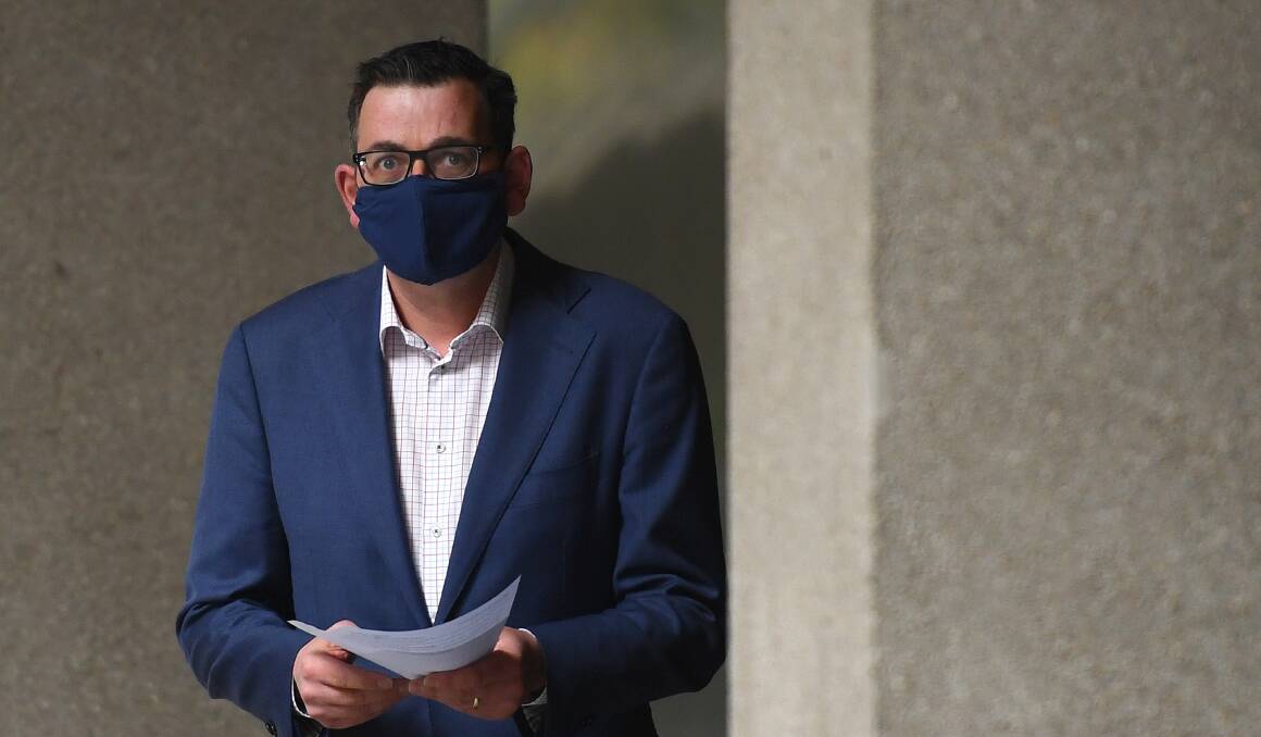 SAFE: Premier Daniel Andrews wears a mask to a press conference.