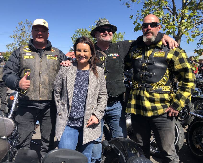MATES: Senator Jacqui Lambie with veterans after she arrived at the opening of the Cockatoo Rise War Veterans Retreat on the back of a motorbike.