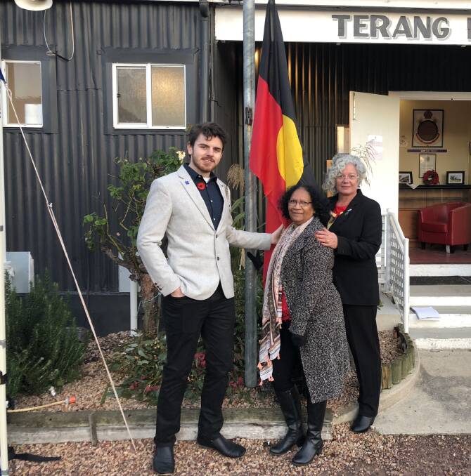 HISTORY REMEMBERED: Franklin Moon, Dr Eileen Harrison and Denise Moon stand by the Aboriginal flag which was unfurled at the dawn service in Terang.