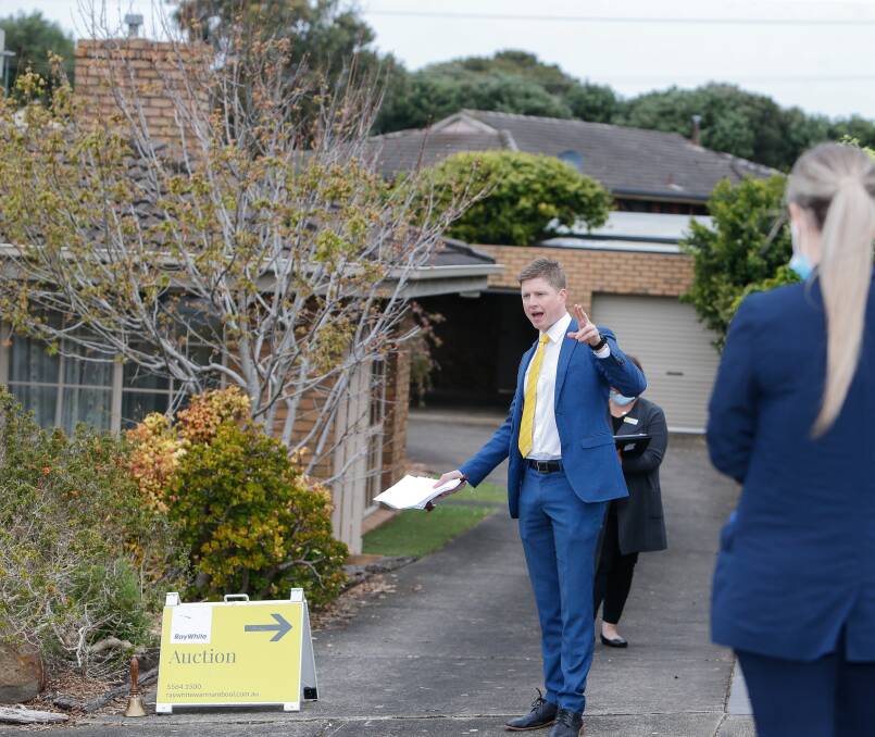SELLING: Ray White director Fergus Torpy auctions a house on Fairway Crescent on Saturday, the auction was one of nine held over Friday and Saturday. Picture: Anthony Brady